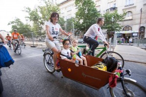 Two children and woman on bike