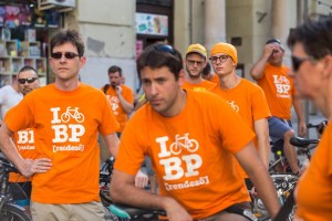 Men on bikes wearing orange t shirt