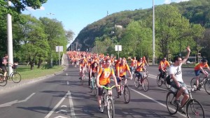 People cycling wearing orange shirts